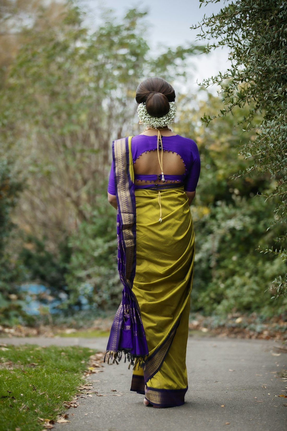 Yellow and purple saree on an open road at noon